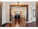 Formal dining room with hardwood floors, a glass-top table, and blue velvet chairs at 4009 Oakley Way, Lakeland, FL 33813