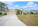 House with a large driveway and a neatly kept lawn at 4009 Oakley Way, Lakeland, FL 33813