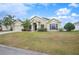 Well-maintained house with a spacious lawn and palm trees at 4009 Oakley Way, Lakeland, FL 33813