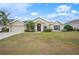 One-story home with attractive landscaping and a two-car garage at 4009 Oakley Way, Lakeland, FL 33813