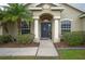 Front entrance with columns, a dark door, and landscaping at 4009 Oakley Way, Lakeland, FL 33813