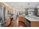 Modern kitchen with wood cabinets, granite countertops, and stainless steel appliances at 4009 Oakley Way, Lakeland, FL 33813