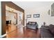 Living room with hardwood floors, brown leather couches, and decorative wall art at 4009 Oakley Way, Lakeland, FL 33813