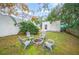 Backyard with firepit and seating area, surrounded by trees at 401 E Belmar St, Lakeland, FL 33803