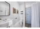 Modern bathroom featuring a mosaic tile shower and floating shelves at 401 E Belmar St, Lakeland, FL 33803