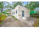 Rear view of stucco house with detached garage and a small yard at 401 E Belmar St, Lakeland, FL 33803