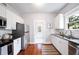 Modern kitchen with white cabinets, granite countertops, and stainless steel appliances at 401 E Belmar St, Lakeland, FL 33803