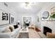 Light-filled living room with white sofa, fireplace, and hardwood floors at 401 E Belmar St, Lakeland, FL 33803