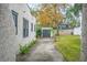 Home's side yard with a long driveway, detached garage, and lush landscaping at 401 E Belmar St, Lakeland, FL 33803