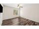 Simple bedroom with hardwood floors and a large window offering natural light at 4048 Windchime Ln, Lakeland, FL 33811