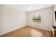 Well-lit bedroom with hardwood floors and large window at 4048 Windchime Ln, Lakeland, FL 33811