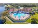 Aerial view of community pool with lounge chairs and a clubhouse at 4048 Windchime Ln, Lakeland, FL 33811