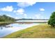 Scenic lake view with blue skies and puffy white clouds, highlighting the serene backyard at 4048 Windchime Ln, Lakeland, FL 33811