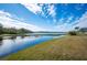 Peaceful lake view from a backyard with lush grass at 4048 Windchime Ln, Lakeland, FL 33811