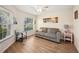 Bright living room featuring hardwood floors, large windows, and comfortable seating at 4048 Windchime Ln, Lakeland, FL 33811