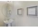 Small half bathroom with pedestal sink and decorative wall art at 4179 Oaktree Dr, Davenport, FL 33837