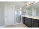 Spa-like bathroom with a walk-in shower and dark brown vanity at 4179 Oaktree Dr, Davenport, FL 33837