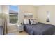 Bright bedroom featuring a full-size bed and ample natural light at 4179 Oaktree Dr, Davenport, FL 33837