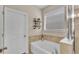 Relaxing bathroom with soaking tub, decorative shelves and window at 4224 Prima Lago Dr, Lakeland, FL 33810