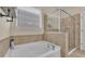 Clean bathroom with a soaking tub and walk-in shower at 4224 Prima Lago Dr, Lakeland, FL 33810