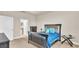 Bright bedroom with a queen bed, dresser, and ensuite bathroom access at 4224 Prima Lago Dr, Lakeland, FL 33810