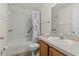 Guest bathroom with shower/tub combo, vanity, and linen storage at 4308 Whistlewood Cir, Lakeland, FL 33811