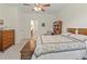 Main bedroom with large bed, dresser, and access to bathroom at 4308 Whistlewood Cir, Lakeland, FL 33811