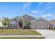 Single-story house with a two-car garage and attractive landscaping at 4308 Whistlewood Cir, Lakeland, FL 33811