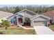 One-story house with red door and attached garage at 4308 Whistlewood Cir, Lakeland, FL 33811