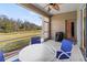 Relaxing screened patio with table and chairs, overlooking a grassy backyard at 4308 Whistlewood Cir, Lakeland, FL 33811