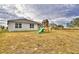 Fenced backyard with playset, offering a safe play area at 442 Jacks Way, Davenport, FL 33837