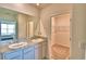 Bathroom with double vanity, granite countertop, and walk-in closet at 442 Jacks Way, Davenport, FL 33837