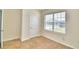 Bright bedroom with window and neutral-toned walls at 442 Jacks Way, Davenport, FL 33837