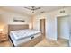 Main bedroom with a queen bed, ceiling fan, and en-suite bathroom at 442 Jacks Way, Davenport, FL 33837