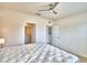 Main bedroom with a queen bed, ceiling fan, and access to a bathroom at 442 Jacks Way, Davenport, FL 33837