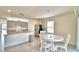 Bright dining area with white table and chairs near kitchen at 442 Jacks Way, Davenport, FL 33837