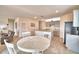 Casual dining area with white table and chairs, views into kitchen at 442 Jacks Way, Davenport, FL 33837