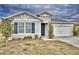 One-story home with gray siding, blue shutters, and a two-car garage at 442 Jacks Way, Davenport, FL 33837