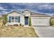 One-story home with gray siding, blue shutters, and a two-car garage at 442 Jacks Way, Davenport, FL 33837