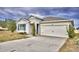 One-story home with gray siding, blue shutters, and a two-car garage at 442 Jacks Way, Davenport, FL 33837