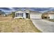 One story home with gray siding, blue shutters, and a two-car garage at 442 Jacks Way, Davenport, FL 33837