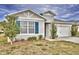 One-story house with gray siding, blue shutters, and a two-car garage at 442 Jacks Way, Davenport, FL 33837