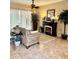 Comfortable living area featuring tile flooring, a decorative fireplace, and a large window at 4435 Fairway Oaks Dr, Mulberry, FL 33860