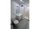 Updated bathroom with white vanity, toilet and shower at 4517 Oak St, Lakeland, FL 33813