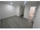 Bedroom with grey wood-look floors and an ensuite bathroom at 4517 Oak St, Lakeland, FL 33813