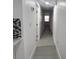 Long hallway with gray flooring and access to bedrooms at 4517 Oak St, Lakeland, FL 33813