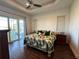 Main bedroom with leafy patterned bedding and sliding glass doors at 593 Meandering Way, Polk City, FL 33868