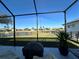 Screened lanai with lake view, offering relaxing outdoor space at 593 Meandering Way, Polk City, FL 33868