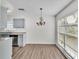 Dining area with wood-look floors and a chandelier, adjacent to the kitchen at 6111 Morningview Dr, Lakeland, FL 33813