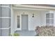 Gray front door with sidelights, leading to the entrance of the house at 6111 Morningview Dr, Lakeland, FL 33813